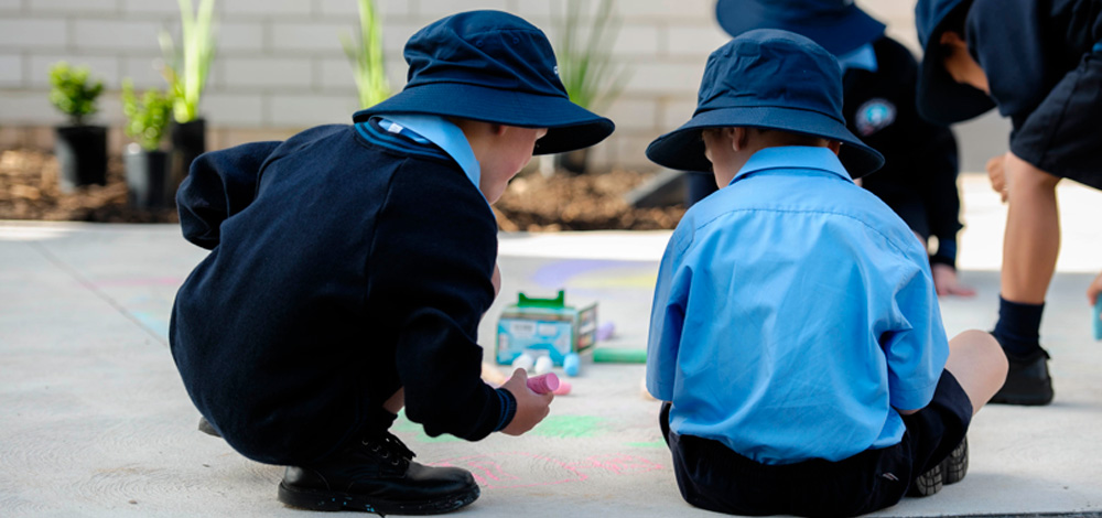 image of children drawing with chalk